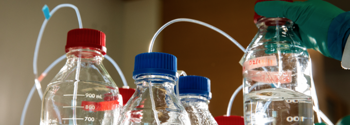 UB student Madison Williams works with a local high school student in a chemistry lab. 