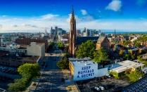 A mural with the text ‘Keep Buffalo A Secret’ is displayed on a building on Main Street in downtown Buffalo. NY. 