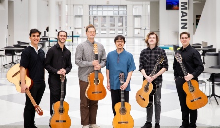Six guitar players pose in the artirum of the Center for the Arts. 