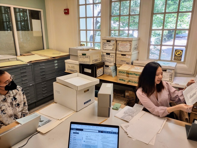 Student reading working in the archives. 