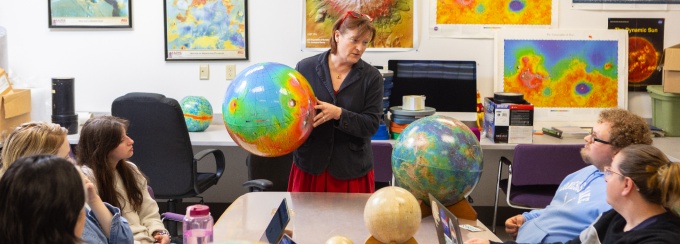 Tracy Gregg teaches a graduate class. 