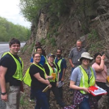 Students examining rocks in a road cut. 