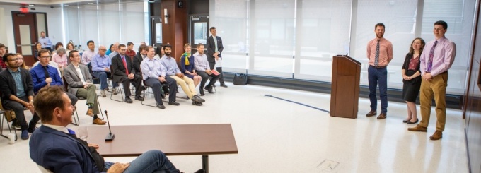 Students from GLY479/579: The Carbon Reduction Challenge presenting to Congressman Higgins (seated, foreground) and the UB community on Earth Day, 2019. (students presenting L to R: Jeremy Stock, Geology BS ’18 MS ’20; AmyGrogan, Geology MS ’20; Quinn Keenan, Engineering MS ’19). 