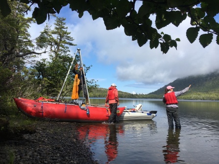 UB Graduate students Karlee Prince (pointing) and Caleb Walcott (on boat), along with UB Geology Professor Elizabeth Thomas (middle) at a research site in SE Alaska. 