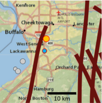 Zoom image: Figure 3. The grey dots are earthquakes from USGS, as is the base map. The February 2023 earthquake epicenter is the orange dot, and the blue dot just south of the orange dot is an earthquake that occurred in September 2022. The brown lines are the approximate trace of proposed faults from Jacobi (2002). The faults are mostly not mapped in the Buffalo area because the lineaments, geology, and aeromag are masked by cultural development. NW/NNW-striking and ENE-striking faults also extend toward Buffalo, and intersections among all these fault systems could make the area more susceptible to failure. The large number of possible faults also makes it difficult to definitively assign a single fault to observed events. 