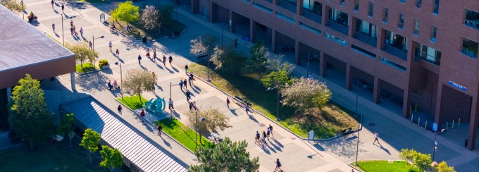 Aerial shot of students walking by Baldy Hall. 