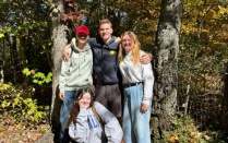 Students gathered for a group photo in the woods. 