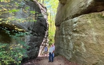 A student in between two large boulders. 