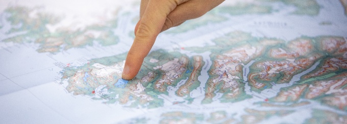 Student pointing at a glacier map. 