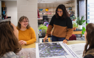 Students reviewing glacier modeling poster. 