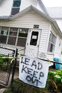 House with a sign that says: Lead keep out. 