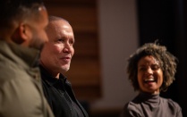 Zoom image: Michael Abels (center), an American composer, speaks with prof. Melissa White (right) and Marshall Lindsey (left), on the stage in the Baird Hall Recital Hall in April 2024. Photographer: Meredith Forrest Kulwicki