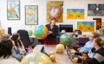 Zoom image: Tracy Gregg, with geology, teaches a graduate class, in Hochstetter Hall in April 2024. Gregg specializes in volcanology, including volcanoes on Mars and Venus. Photographer: Douglas Levere