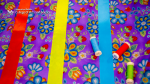 Zoom image: A closeup of ribbon and fabric with the College of Arts and Sciences logo.