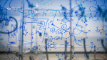 Zoom image: Chemistry formulas are written on a glass wall.