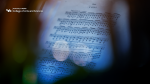 Zoom image: A closeup of sheet music with the College of Arts and Sciences logo.