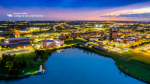 Zoom image: Arts and Sciences logo with a night view of North Campus and Lake laSalle for video conferencing.