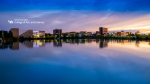 Zoom image: Arts and Sciences logo with a view of North Campus at sunset for video conferencing.