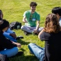Research students sitting in a circle talking. 