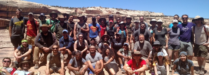 Zoom image: Field camp 2018 Geology students and staff, photo was taken at Bridges National Monument, Utah. 