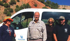 Tracy Gregg, Ken Hilfker, and Patti Phillips in front of a mountain. 