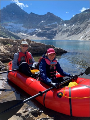 Gabby Feber and Scott King sitting in a boat on the edge of Lake McArthur in Yoho National Park. 