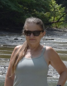Beata Csatho with a running creek behind her. 