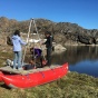 The researchers built a simple pontoon. They rode the boat into the middle of isolated lakes to collect samples of lake-bottom mud, which holds clues about the history of precipitation in a region in Greenland. 