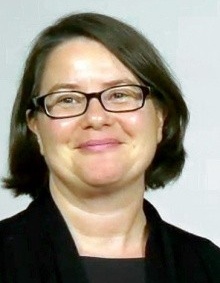 Professor, Margarete Jadamec dark above the shoulder length hair, black rimmed eyeglasses and a black shirt and jacket. 