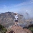 Brendan Ash standing atop a mountain. 