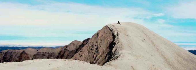 A student atop a rock formation. 