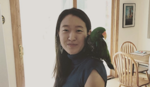 Genie Yoo with her parrot on her shoulder. 