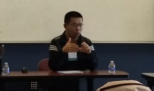Tianyu Liu speaks at conference. 