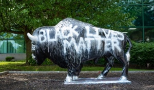Bull sculpture painted to say Black Lives Matter. 