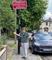 Prof. Kristin Stapleton in Southampton, UK standing under a street sign. 