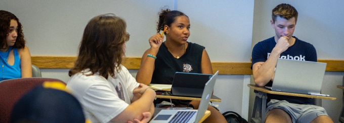 A student participates in a discussion in a History class. 