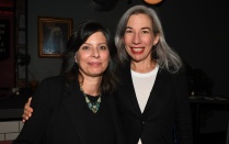 Photo of Humanities Institute Director Elizabeth (Libby) Otto and Executive Director Christina Milletti, standing arm-in-arm, at a reception. 