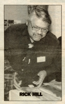 Image of a man with glasses looking at materials. The name Rick Hill is on the photo. 