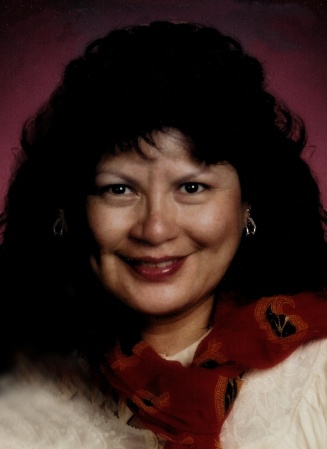 Image of a woman with dark hair looking into a camera. 