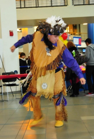 Zoom image: Man in indigenous dress demonstrating dance.