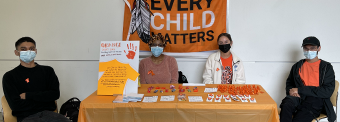 students at a tabling event, Every Child Matters. 