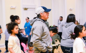 Zoom image: Individuals standing in a line during social dance.