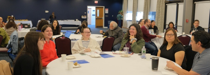A group of people sitting at a table during an event. 
