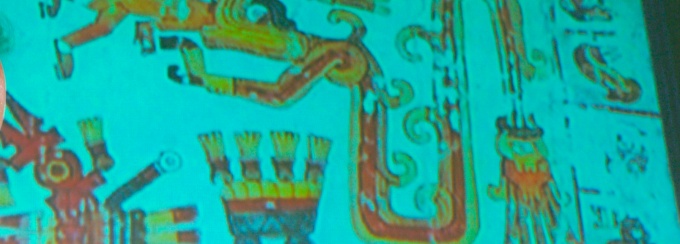 Mayan hieroglyphics projected on a screen during a talk at UB. 