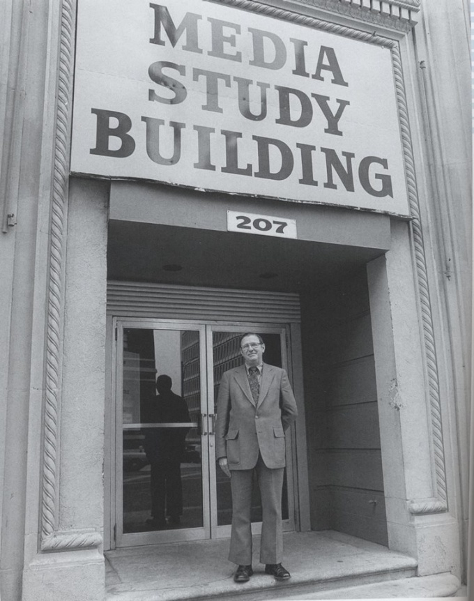 Gerry O'Grady in front of Media Study Buffalo sign in downtown Buffalo.