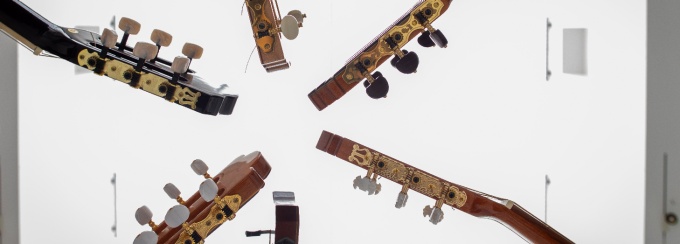 Six guitars are arranged in a star. 