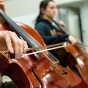 A closeup of a student playing the cello. 