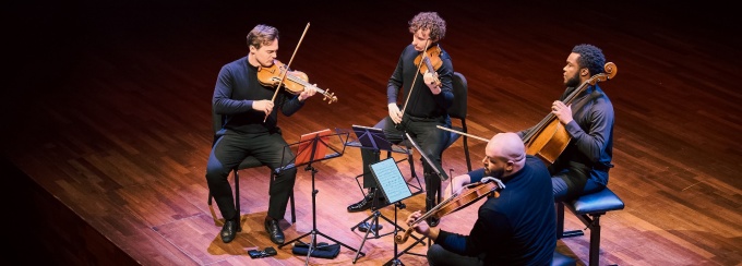 Isadore String Quartet playing on a stage. 