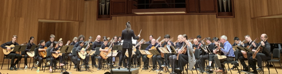 Musicians playing on stage in Slee Hall. 