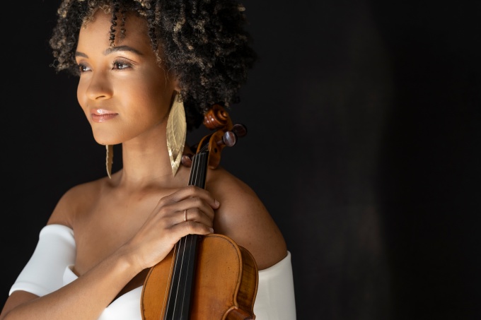 Melissa White holding a violin. 